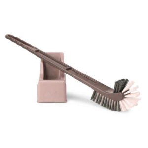 Ergonomic hockey-shaped toilet cleaning brush with a dedicated holder for organized bathroom storage by Krishna Plastic.